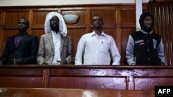 (L-R) Terror suspects Osman Abdi Dagane, Sahal Diriye, Hassan Aden Hassan and Mohamed Ali Abdikar, stand in the dock in Nairobi, Jan. 29, 2019, charged with carrying out a terrorist attack at Garissa University College four years ago. 