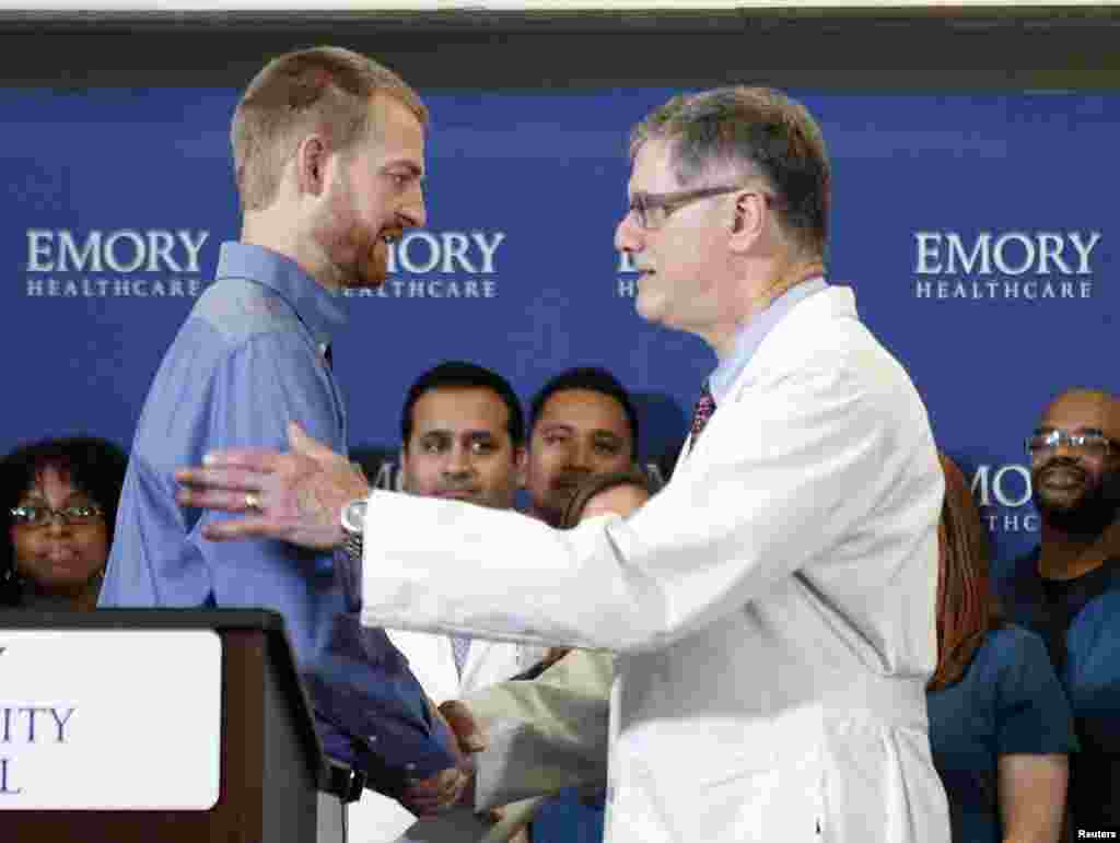 Kevin Brantly (left), who contracted the deadly Ebola virus, thanks Bruce Ribner, medical director of Emory's Infectious Disease Unit during a press conference at Emory University Hospital, in Atlanta, Georgia, Aug. 21, 2014.