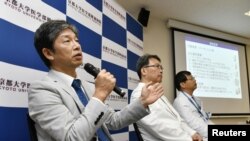 Jun Takahashi, left, professor at Kyoto University's Centre for iPS Cell Research and Application, attends a news conference in Kyoto, Japan, July 30, 2018. 