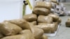 FILE - In this undated photo provided by the Australian Federal Police, packages containing methamphetamine seized in a shipment coming from China are stacked in a warehouse in Melbourne, Australia.