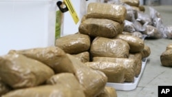 FILE - In this undated photo provided by the Australian Federal Police, packages containing methamphetamine are stacked in a warehouse in Melbourne, Australia.