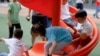 FILE - Children at a playground inside a shopping complex in Shanghai, China, June 1, 2021.