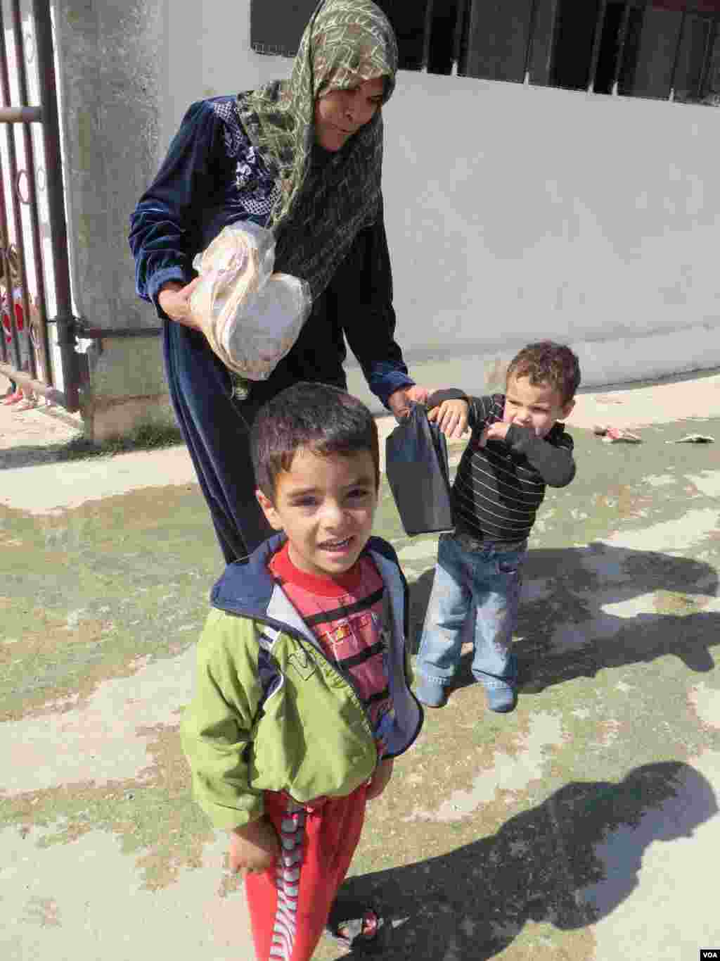 Syrian families come to centers like this one to get basic needs, like bread from aid workers who say they are in desperate need of donations, Bekaa Valley, Lebanon, Sept. 4, 2013. Photo: H. Murdock/VOA 