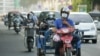Motorcycle riders wear face masks to curb the spread of COVID-19 in Phnom Penh, Cambodia. (Hean Socheata/VOA Khmer)