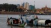 FILE PHOTO - Fishermen row their wooden boats in conjunction with rivers between the Mekong River and Tonle Sap as they catch fish during the fish harvesting season near Phnom Penh, Cambodia, Wednesday, Nov. 28, 2018. (AP Photo/Heng Sinith)