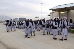 FILE - In this handout photo taken and released on April 11, 2020 by Afghanistan's National Security Council, Taliban prisoners stand before being released from the Bagram prison next to the US military base in Bagram, some 50 km north of Kabul.