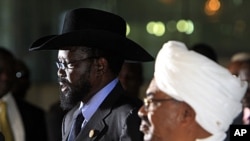 Sudanese President Omar al-Bashir (R) listens as his South Sudanese counterpart Salva Kiir speaks during a joint news conference, before Kiir's departure at Khartoum Airport October 9, 2011.