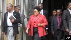 FILE: Joice Mujuru leaves the magistrates courts in Harare, Monday, Feb. 6, 2012, on the last day of the long awaited inquest hearing into the mysterious death of her husband Zimbabwe's former army General Solomon Mujuru.