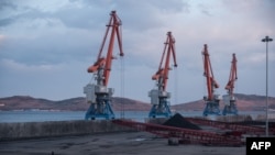 Cranes plus North Korean and Russian coal bound for China are seen at the RasonConTrans coal port at Rajin harbor in the Rason Special Economic Zone, Nov. 21, 2017.