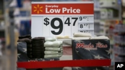 FILE - Towels are seen on display on a sale rack at a Walmart store in Rogers, Arkansas.