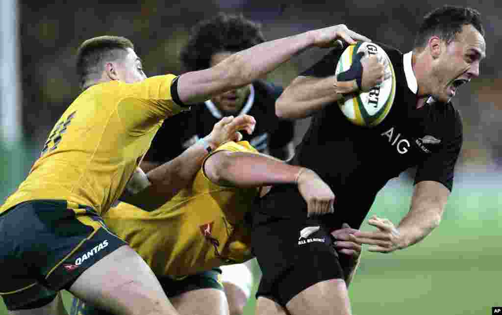 New Zealand&#39;s Israel Dagg, right, is tackled by Australia&#39;s James O&#39;Connor, left, and Ben Alexander during the Bledisloe Cup rugby union match in Sydney, Australia.