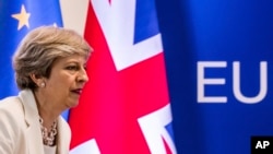 FILE - British Prime Minister Theresa May prepares to address a media conference at an EU summit in Brussels, June 23, 2017. May appears to be looking into an EFTA membership as an alternative to a "hard Brexit."