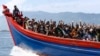 Ethnic Rohingya refugees from Myanmar wave as they are transported by a wooden boat to a temporary shelter in Krueng Raya in Aceh Besar, Indonesia, April 8, 2013.