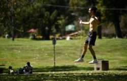 Liam Watkins balances on a slack line at Griffith Park in Los Angeles, April 16, 2020.