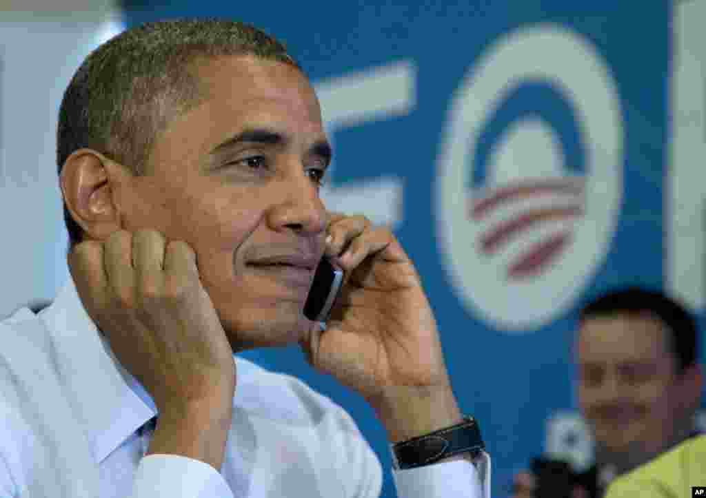 President Barack Obama calls Wisconsin volunteers as he visits a campaign office call center the morning of the 2012 election in Chicago, November 6, 2012.