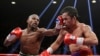 Floyd Mayweather Jr., left, hits Manny Pacquiao, from the Philippines, during their welterweight title fight in Las Vegas, Nevada, May 2, 2015.