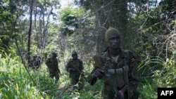 FILE - Soldiers of the Uganda People's Defense Force (UPDF) patrol in the jungle in the Central African Republic as they were looking for Lord's Resistance Army (LRA) fighters.