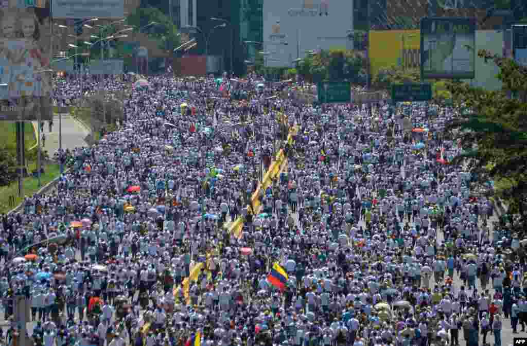 Opposition activists march against President Nicolas Maduro's government in Caracas, Venezuela.