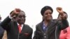 FILE - Zimbabwean President Robert Mugabe and his wife Grace wave to supporters and guests during celebrations to mark his 90th birthday in Marondera about 80km (50 miles) east of the capital Harare, Feb. 23, 2014. Mugabe turned 90 on February 21. RE