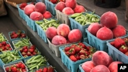 This photo taken June 8, 2013 shows peaches, strawberries, and snap peas are for sale at a roadside market outside Gettysburg, Pa.