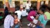 Women wait to have a malaria vaccine administered to their children at the comprehensive Health Centre in Agudama-Epie, in Yenagoa, Nigeria, Dec. 9, 2024.