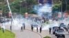 FILE - Nigerian security forces lob teargas canisters to disperse demonstrators gathered for the second day to protest against bad governance and economic hardship in Abuja, Aug. 2, 2024.
