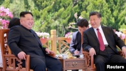 North Korean leader Kim Jong Un meets with China's President Xi Jinping, in Dalian, China in this undated photo released on May 9, 2018 by North Korea's Korean Central News Agency (KCNA).