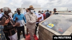 Kenya's President Uhuru Kenyatta unveils the first berth of Chinese-funded Lamu Port in Lamu, Kenya, May 20, 2021. 