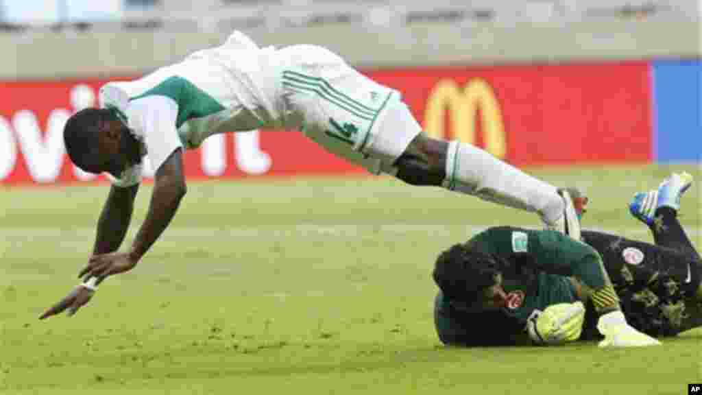 Nigeria's Anthony Ujah, left, is stopped by Tahiti goalkeeper Mikael Roche during the Confederations Cup match between Tahiti and Nigeria.