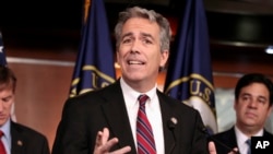 FILE - Former U.S. Rep. Joe Walsh, R-Ill., gestures during a news conference on Capitol Hill in Washington. 