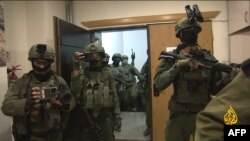 An image grab from footage distributed by the Doha-based Al-Jazeera TV on September 22, 2024 shows Israeli soldiers entering Al Jazeera's office in Ramallah, in the West Bank to issue a 45-day closure order on September 21.