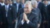 FILE: Cambodia's King Norodom Sihamoni, center, greets his government officials upon his arrival for the water festival in front of Royal Palace in Phnom Penh, Cambodia, Sunday, Nov. 13, 2016.