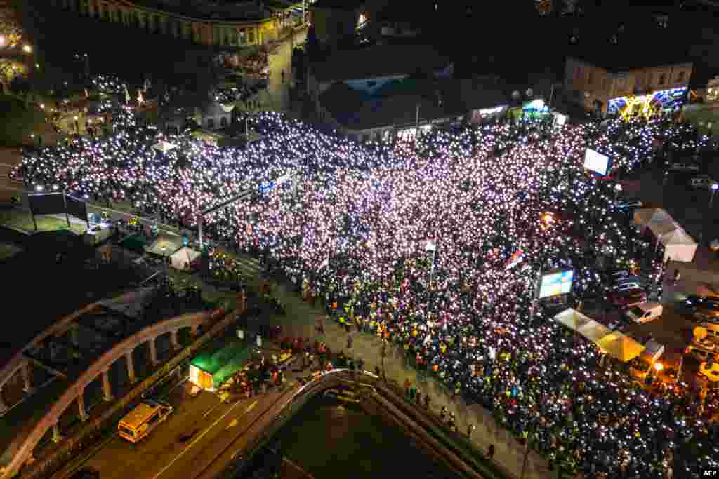 People demonstrate on a main boulevard in the central Serbian city of Kragujevac, Feb, 15, 2025, amid months long calls for government accountability and reforms. The demonstration is the latest in a series of mass protests to rock the Balkan country after the collapse of a roof at a train station killed 15 people in the northern Serbian city of Novi Sad.