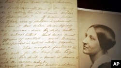 FILE - U.S. women's suffrage leader Susan B. Anthony is seen next to a 1898 letter handwritten by her, at an exhibit at The Karpeles Manuscript Library Museum, in Buffalo, New York, Jan. 10, 2005.