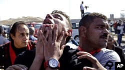 An anti-Hosni Mubarak protester reacts after hearing the verdict of the trial of the former Egyptian president outside a police academy on the outskirts of Cairo, Nov. 29, 2014.