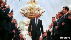 Russian President Vladimir Putin walks before an inauguration ceremony at the Kremlin in Moscow, Russia May 7, 2018. 