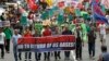 Protesters display placards and banners as they march towards the gates of the U.S. Embassy during a protest in Manila, July 4, 2013. 