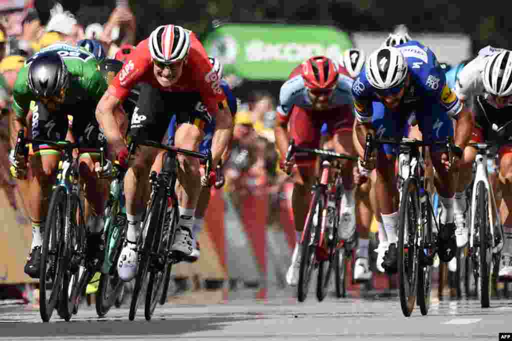 Colombia's Fernando Gaviria (C) sprints during the last meters to cross the finish line ahead of Slovakia's Peter Sagan (L) and Germany's Andre Greipel (2ndL) to win the fourth stage of the 105th edition of the Tour de France cycling race between La Baule and Sarzeau, in western France.
