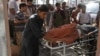 Afganos atienden a un hombre herido por la explosión de una bomba caminera en una carretera entre Herat, en el este del país, y Kandahar, en el sur, en Herat, Afganistán, el 31 de julio de 2019. 