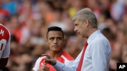  Arsene Wenger, à droite, donnant des instructions à Alexis Sanchez lors d'un match entre Arsenal et Benfica à l'Emirates Stadium