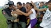 U.S. HSC12 Golden Falcons Chief Julio Grullon, 37, of Naguabo, Puerto Rico, brings fruit to typhoon victims from a delivery of aid from his U.S. Navy Seahawk helicopter in Palo, Philippines, Nov. 20, 2013. 