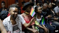 FILE - LGBT activists and supporters attend a Kenyan court ruling on whether to decriminalize same-sex relationships, in Nairobi, Kenya, Feb. 22, 2019.