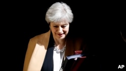 British Prime Minister Theresa May leaves 10 Downing Street in London to take questions at the Houses of Parliament, April 19, 2017.