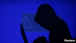 FILE - Three suspects have been accused of attacking more than 100 U.S. companies in recent years and stealing millions of customer credit and debit card records.