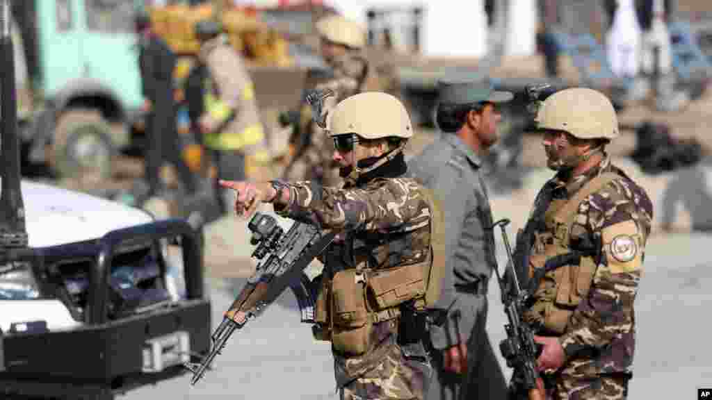 Afghan security forces inspect the site of a suicide attack in Kabul, Afghanistan, Nov. 27, 2014.