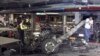 Thai officers examine the wreckage of a pickup truck after an explosion at Samui Island in Surat Thani province, Thailand, April 10, 2015. 