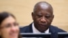 Former Ivory Coast President Laurent Gbagbo waits for the judge to arrive as he appears for the first time at the International Criminal Court (file photo)
