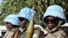 The blue helmets of UN peacekeepers distinguish them from the many armed groups in Darfur