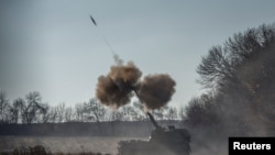 Ukrainian servicemen fire a Polish self-propelled howitzer Krab toward Russian positions in Donetsk region