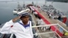 FILE- A Cambodian navy sailor salutes on a Chinese naval patrol boat during a handover ceremony at a Cambodian naval base at Ream in Sihanoukville province, southwest of Phnom Penh, on November 7, 2007. 
